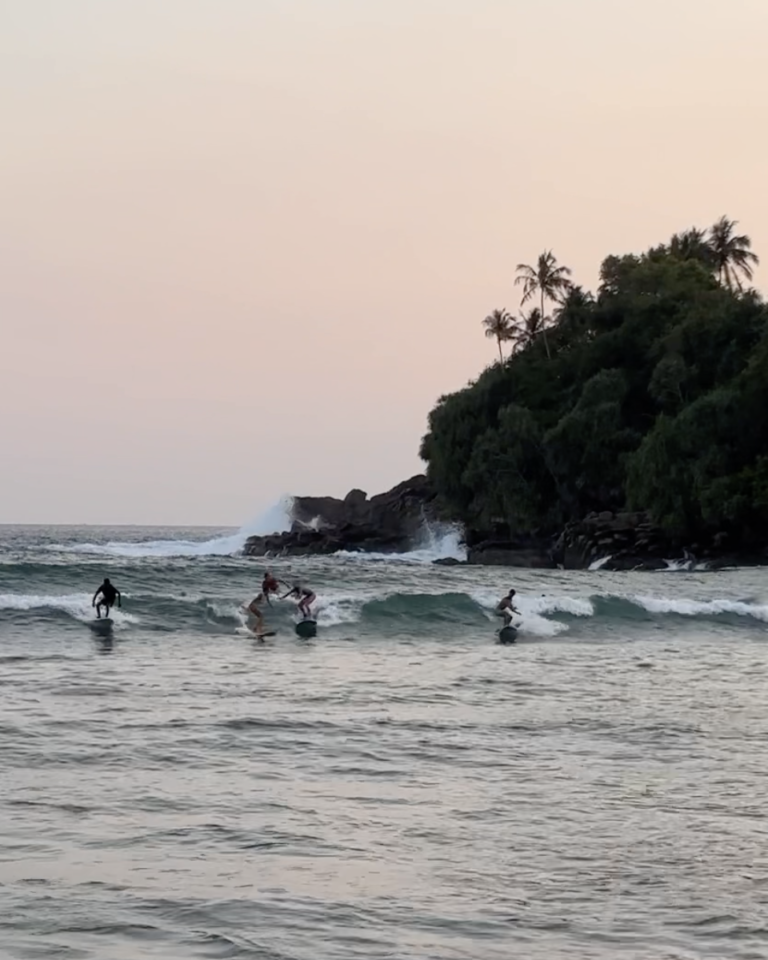 Hiriketiya Bay, surfing under the sunset.